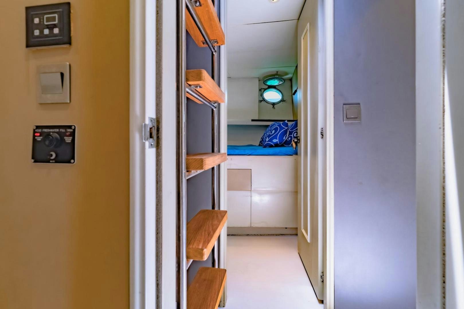 a room with a bed and a mirror aboard DOUBLEYOU Yacht for Sale