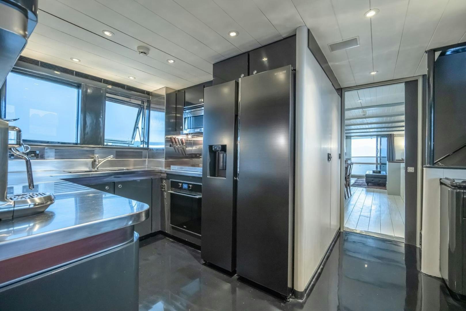 a kitchen with a stainless steel refrigerator aboard DOUBLEYOU Yacht for Sale