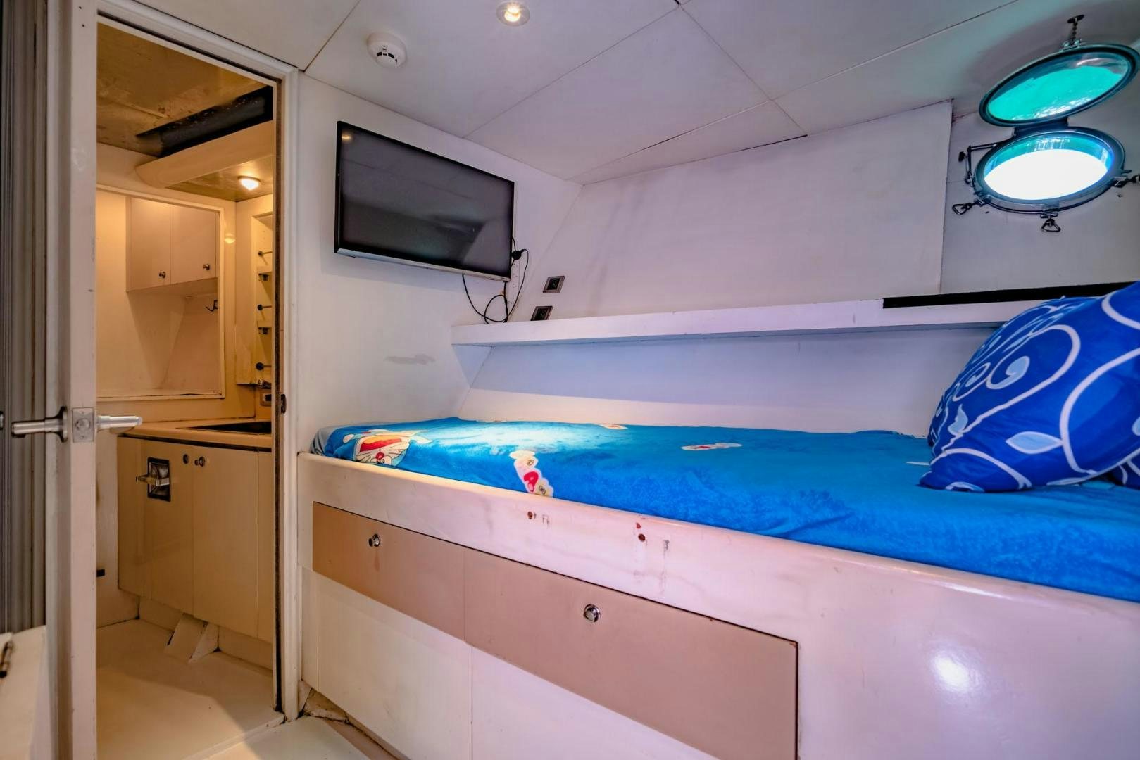 a room with a bed and a television aboard DOUBLEYOU Yacht for Sale
