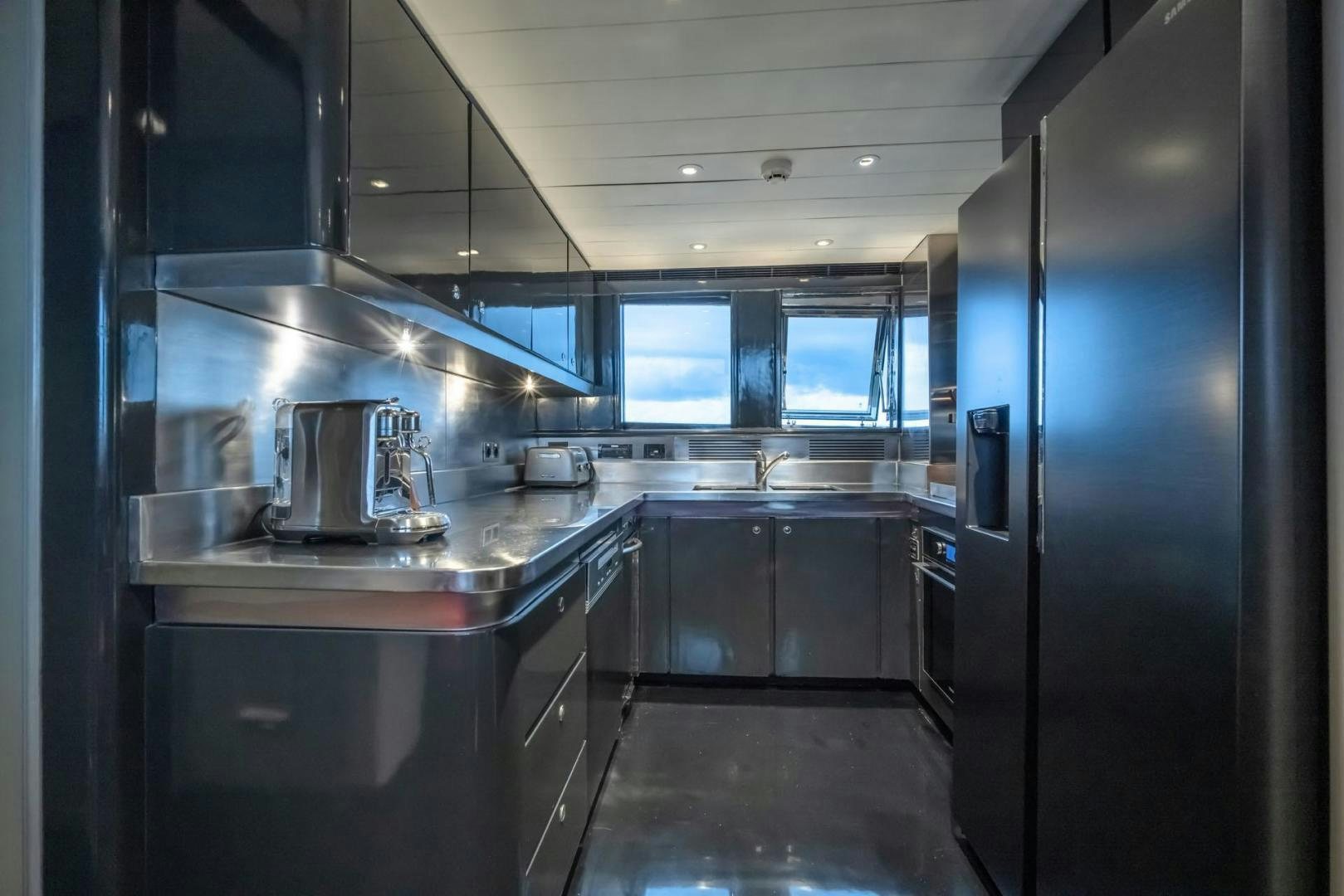 a kitchen with a large refrigerator aboard DOUBLEYOU Yacht for Sale