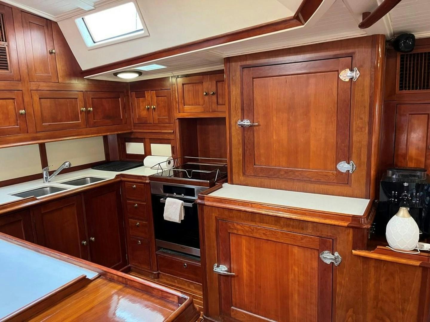 a kitchen with wooden cabinets aboard VOLTERRA Yacht for Sale