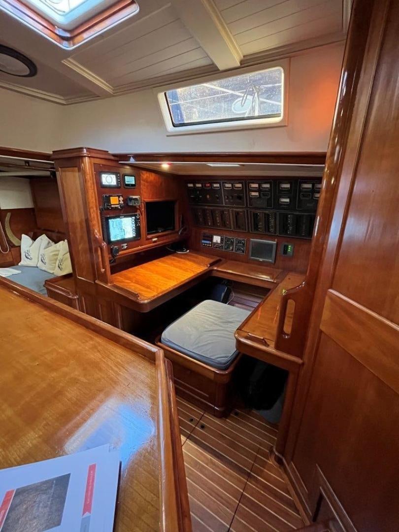a room with a wood cabinet and a chair aboard VOLTERRA Yacht for Sale
