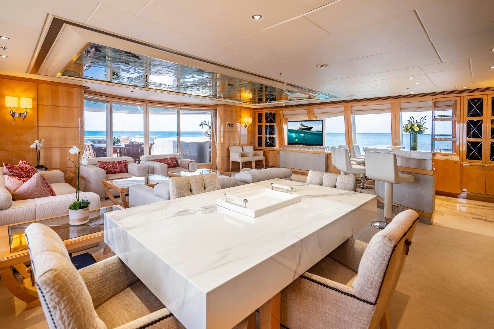 a large living room with a large white table and chairs aboard SOUTH Yacht for Sale