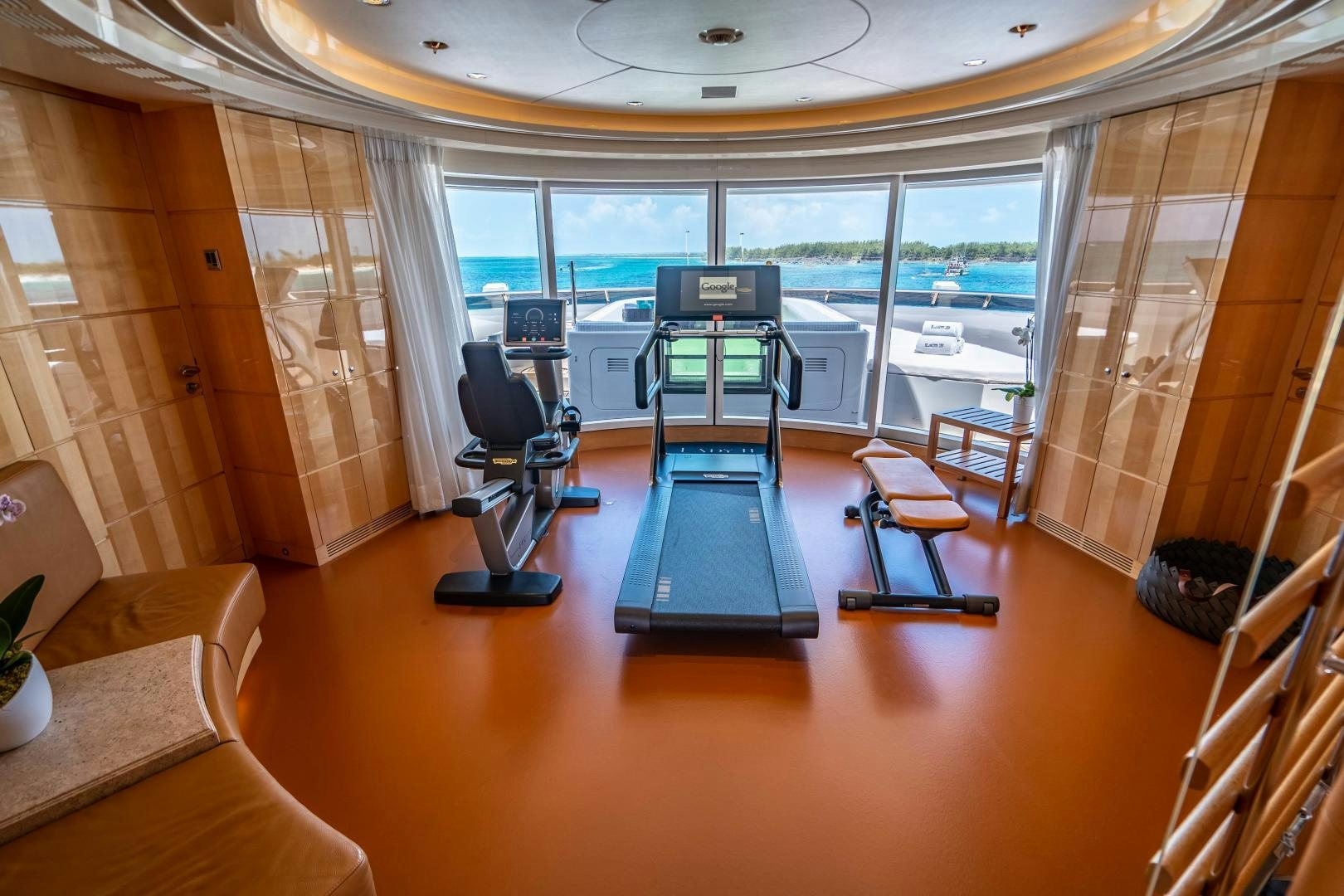 a room with a large window and a table with chairs and a large window aboard SOUTH Yacht for Sale