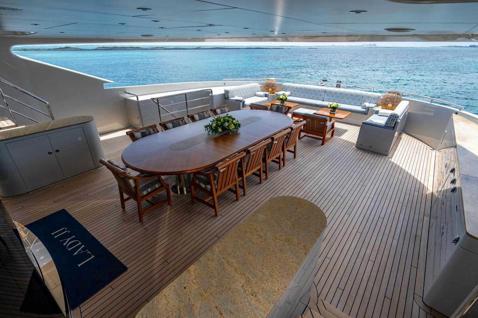 a deck with a table and chairs aboard SOUTH Yacht for Sale