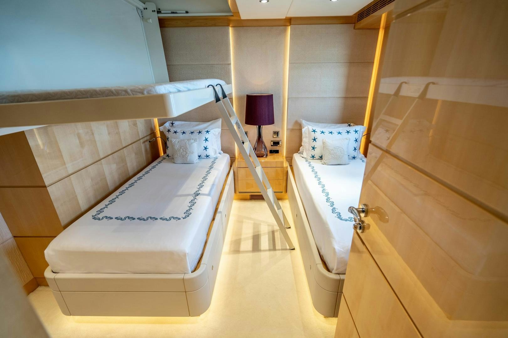 a room with a bed and a lamp aboard SOUTH Yacht for Sale