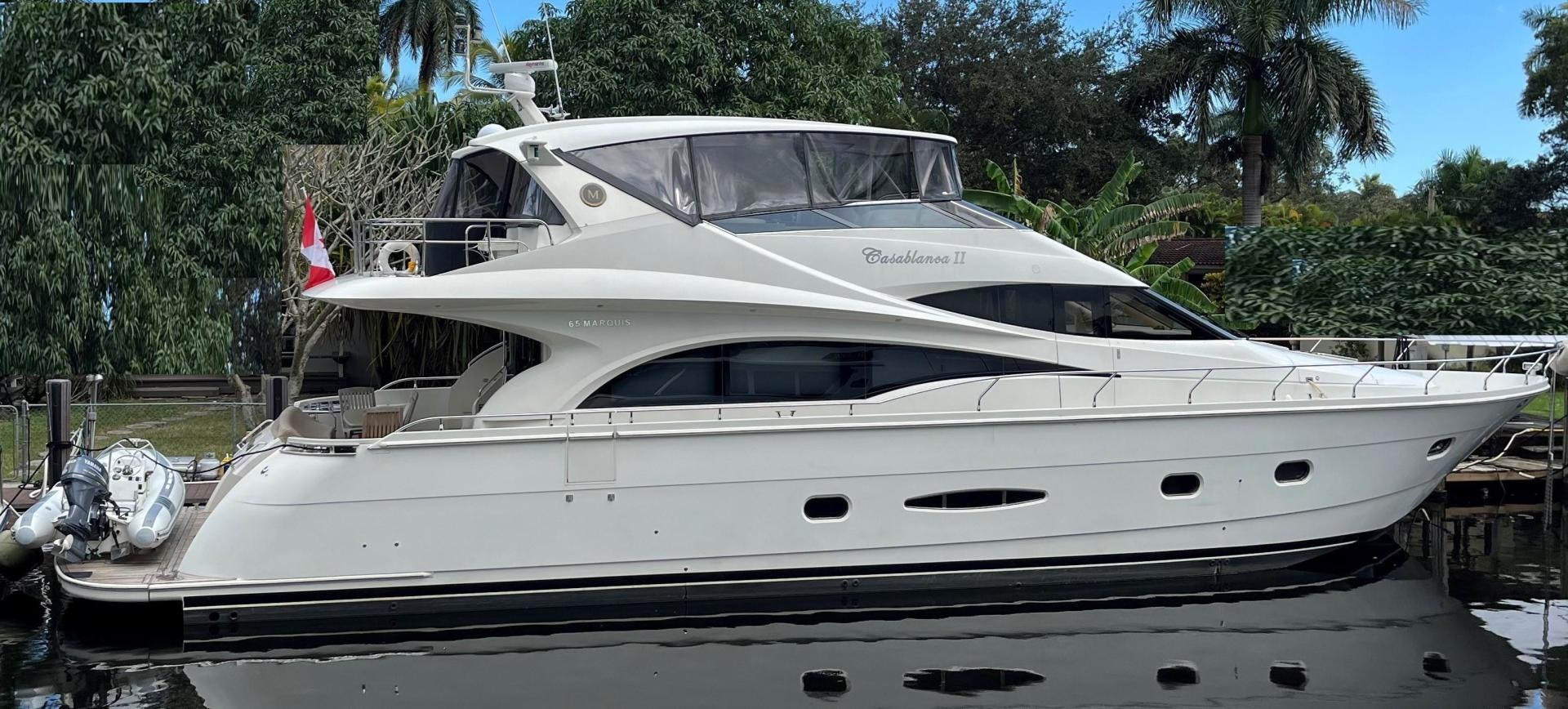 a white yacht parked in a harbor aboard Casablanca II Yacht for Sale