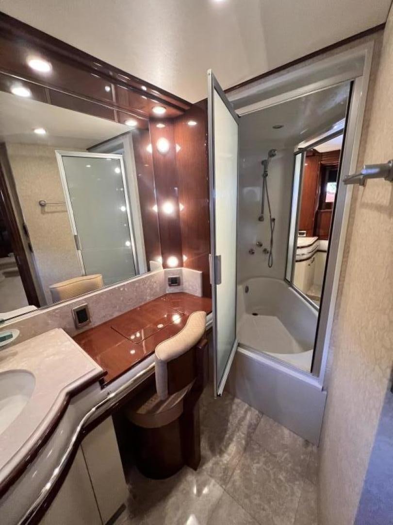 a bathroom with a tub sink and a sink aboard Casablanca II Yacht for Sale