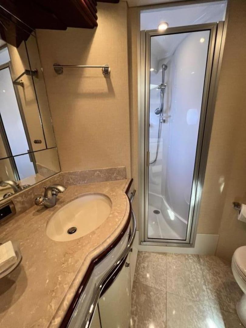 a bathroom with a shower unit and sink aboard Casablanca II Yacht for Sale