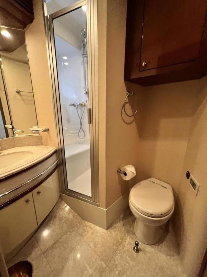 a bathroom with a glass shower door aboard Casablanca II Yacht for Sale