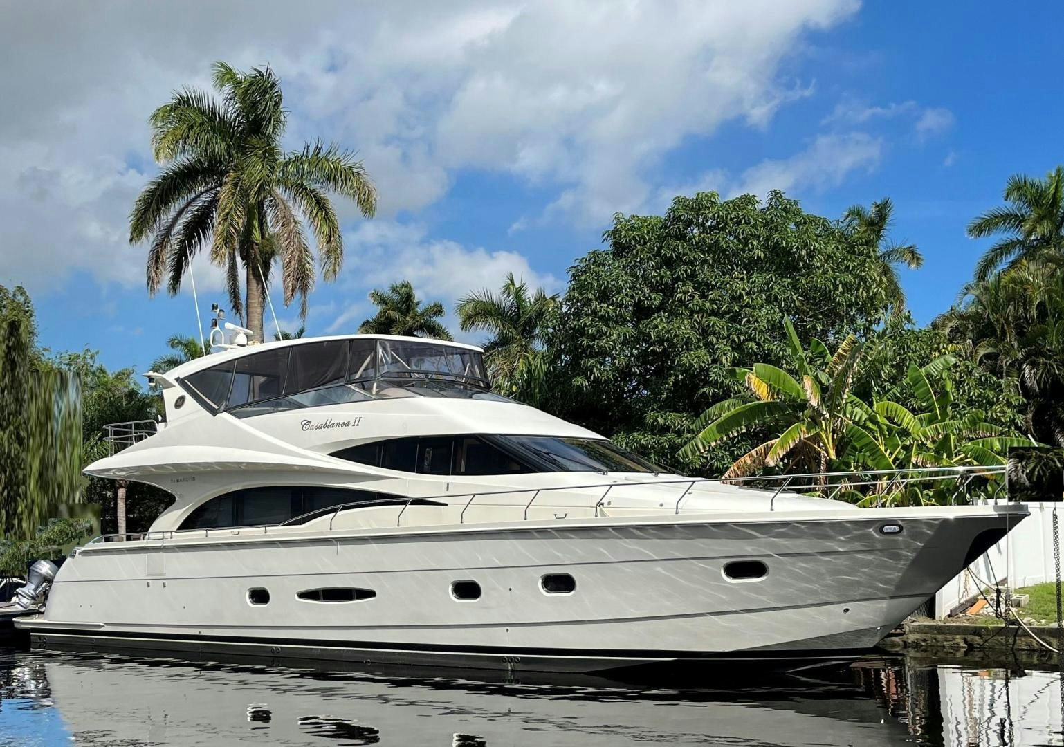 a white yacht on a dock aboard Casablanca II Yacht for Sale