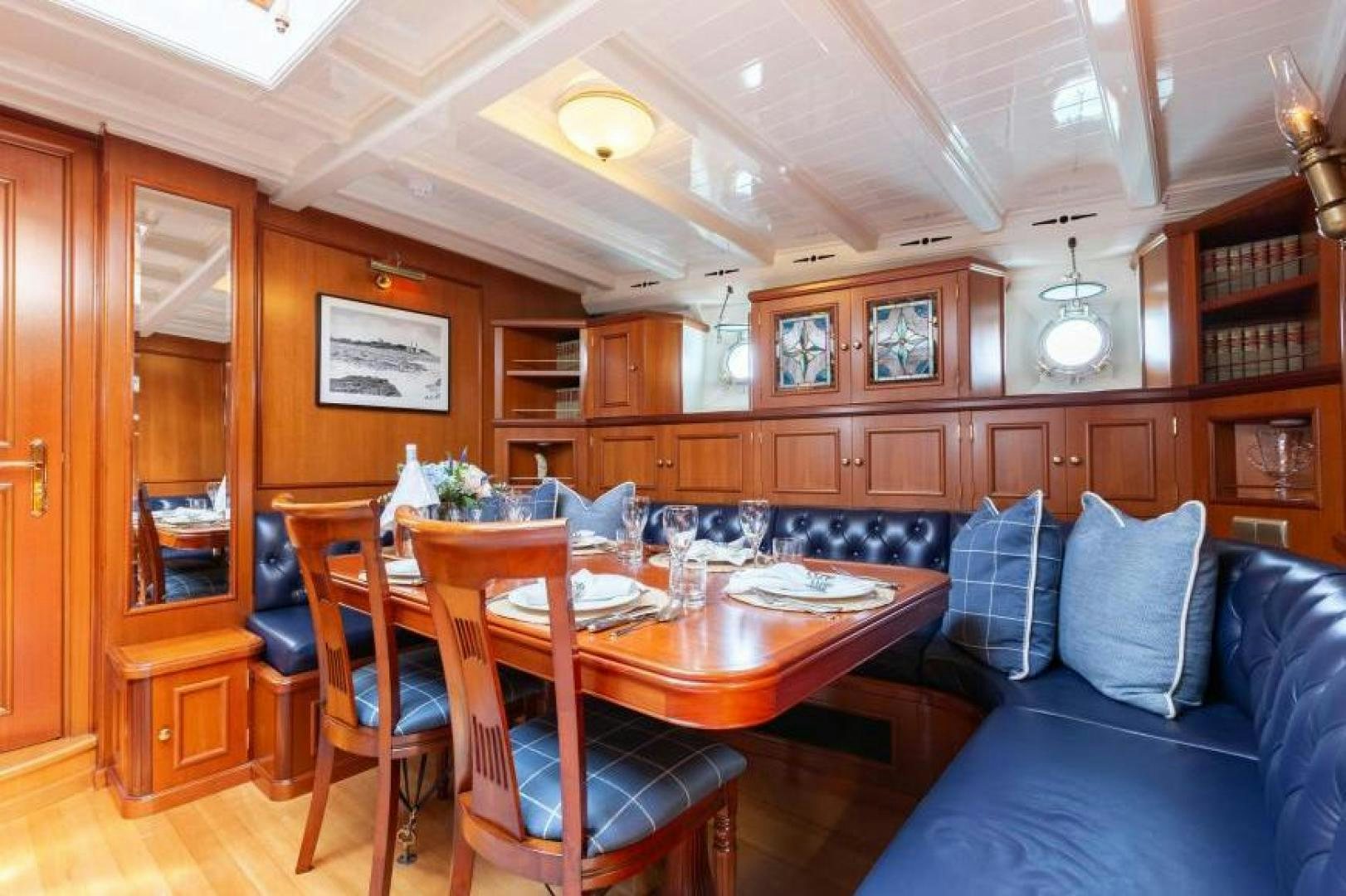 a living room with a couch and a table aboard NAEMA Yacht for Sale