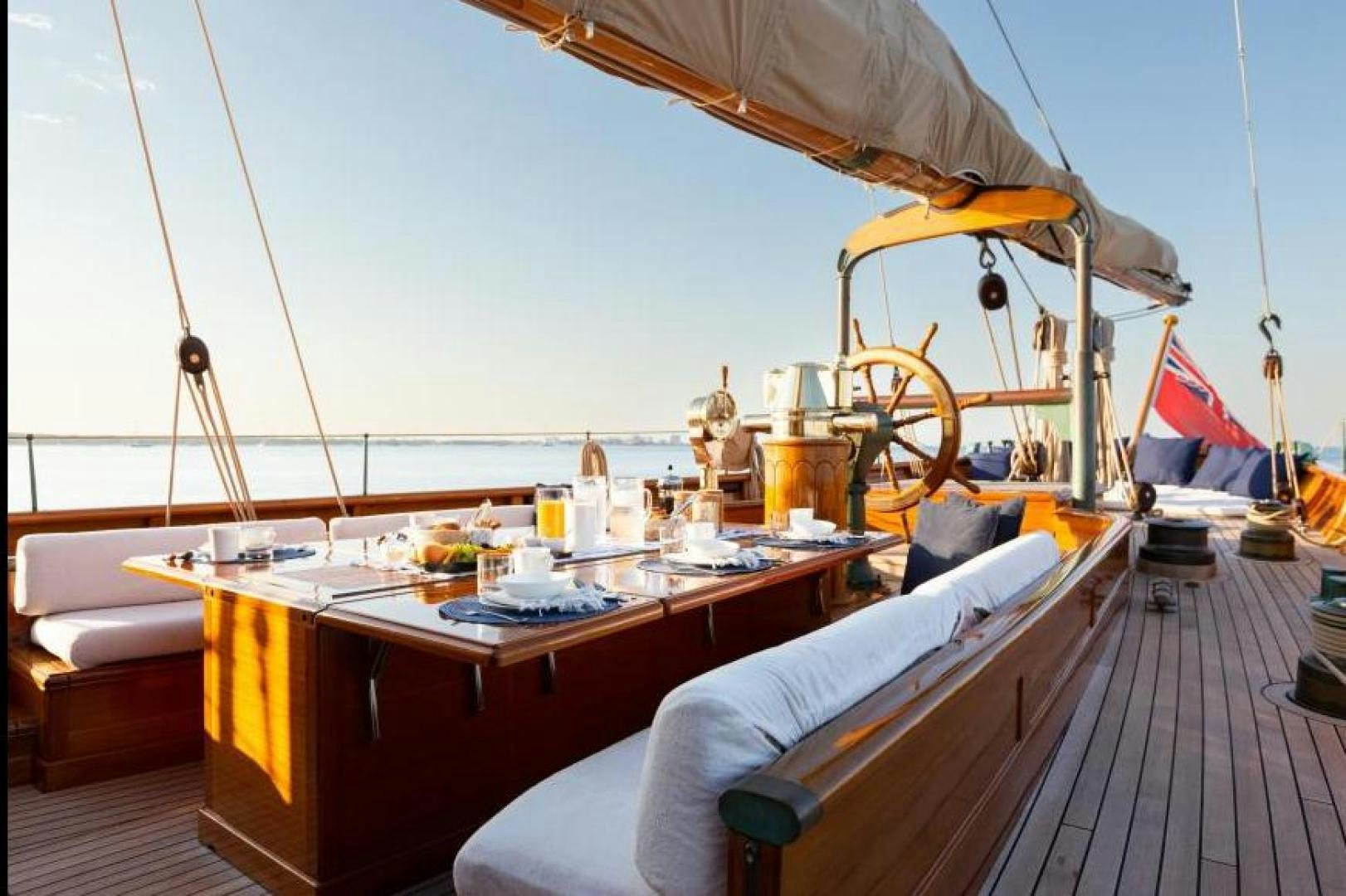 a boat with a table and chairs aboard NAEMA Yacht for Sale