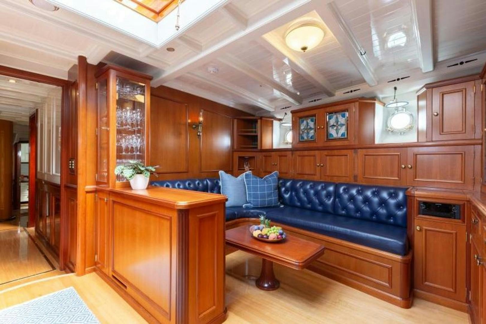 a living room with a blue couch aboard NAEMA Yacht for Sale