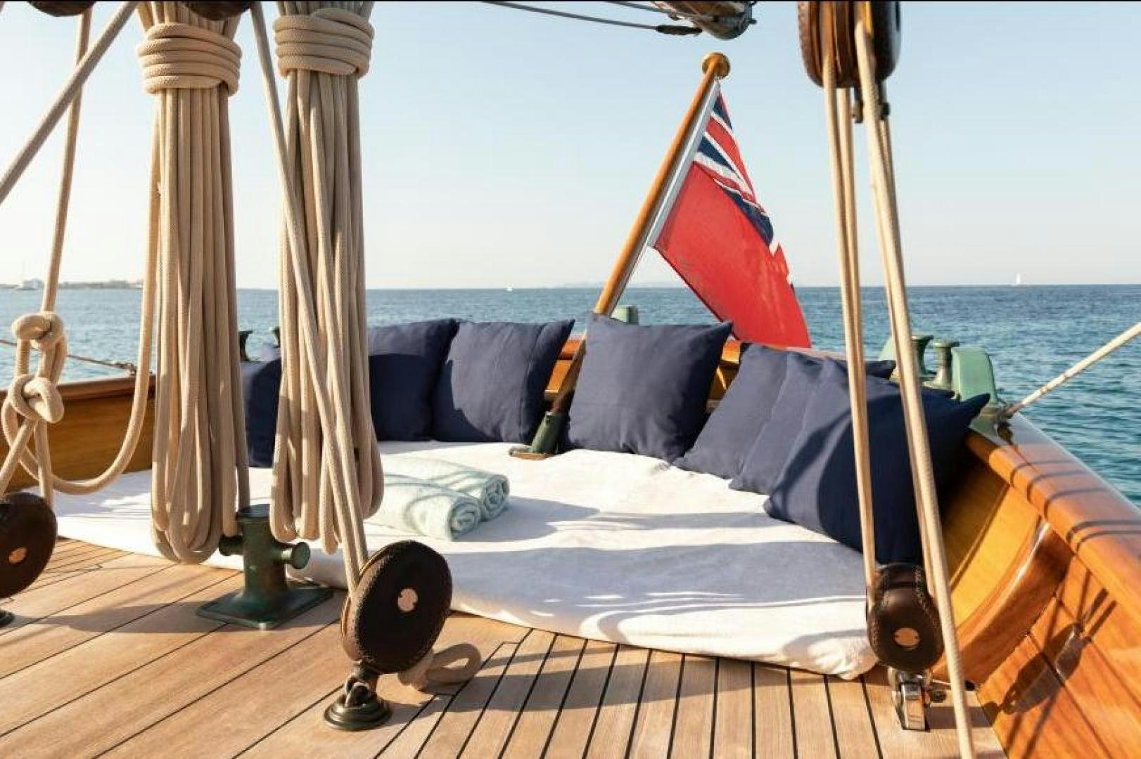 a boat with a flag on the deck aboard NAEMA Yacht for Sale