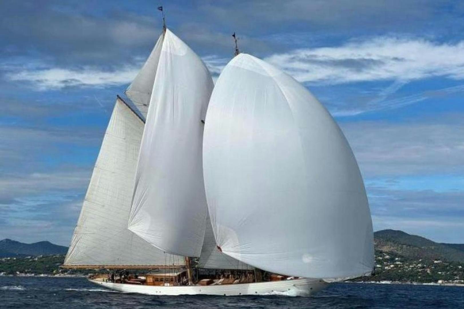 a couple of large white sails on a boat aboard NAEMA Yacht for Sale