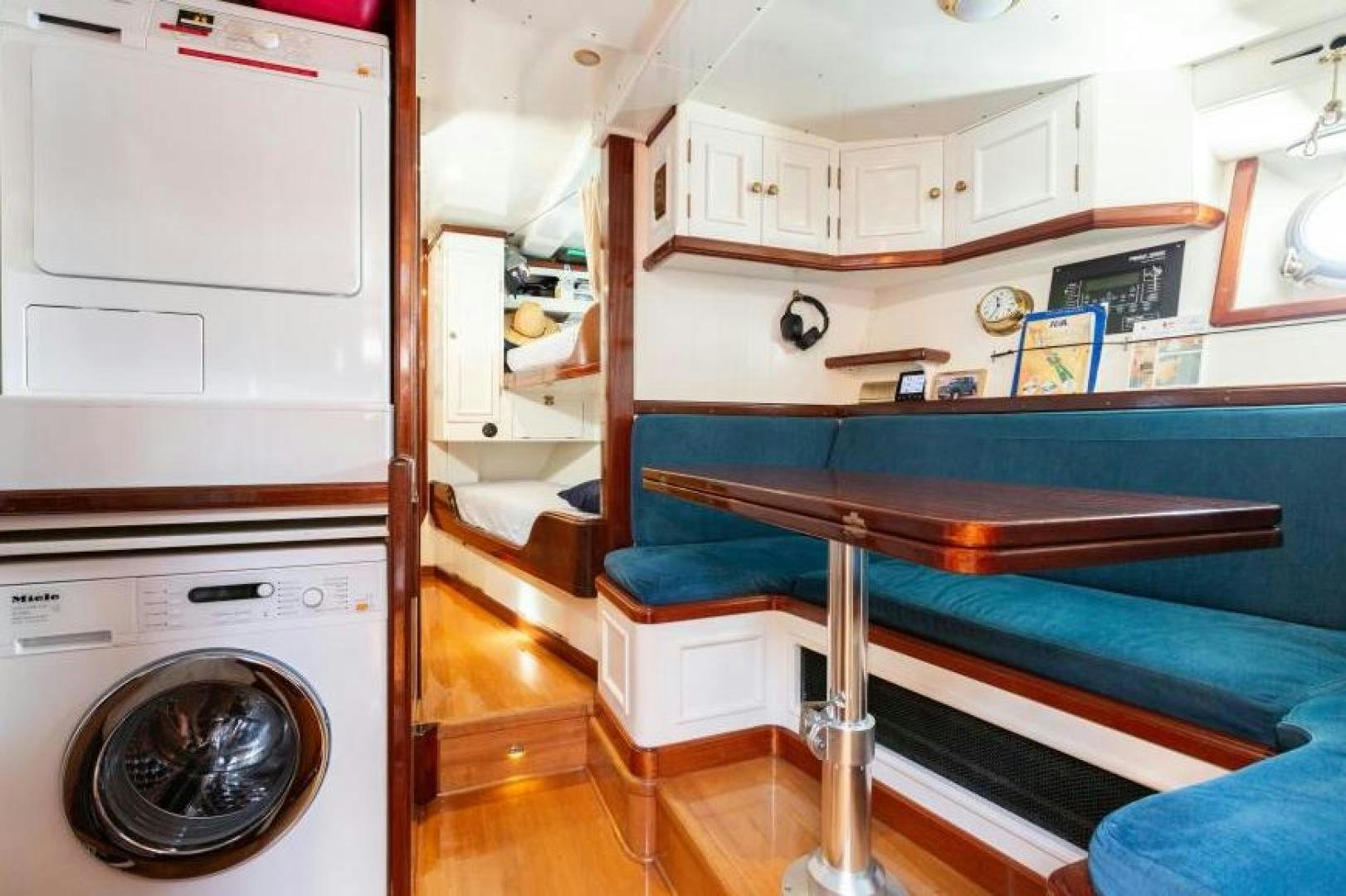 a kitchen with a table and a bed aboard NAEMA Yacht for Sale