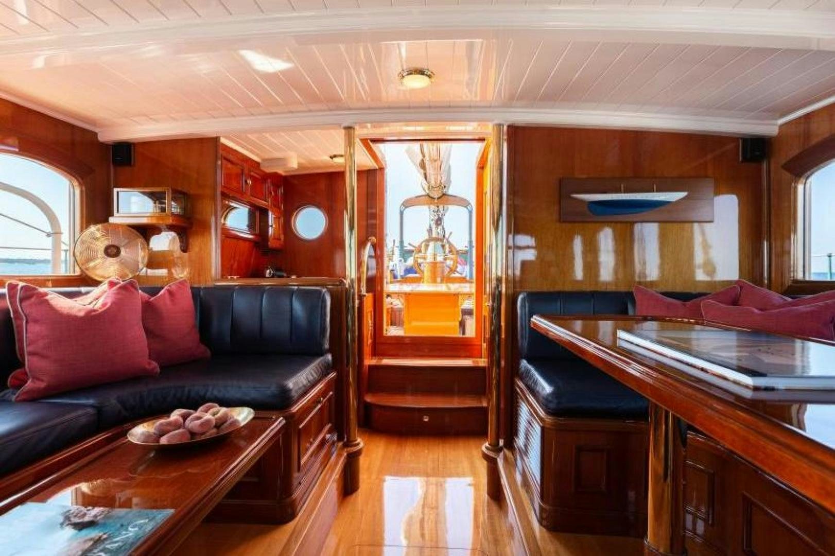 a living room with a couch and a table aboard NAEMA Yacht for Sale