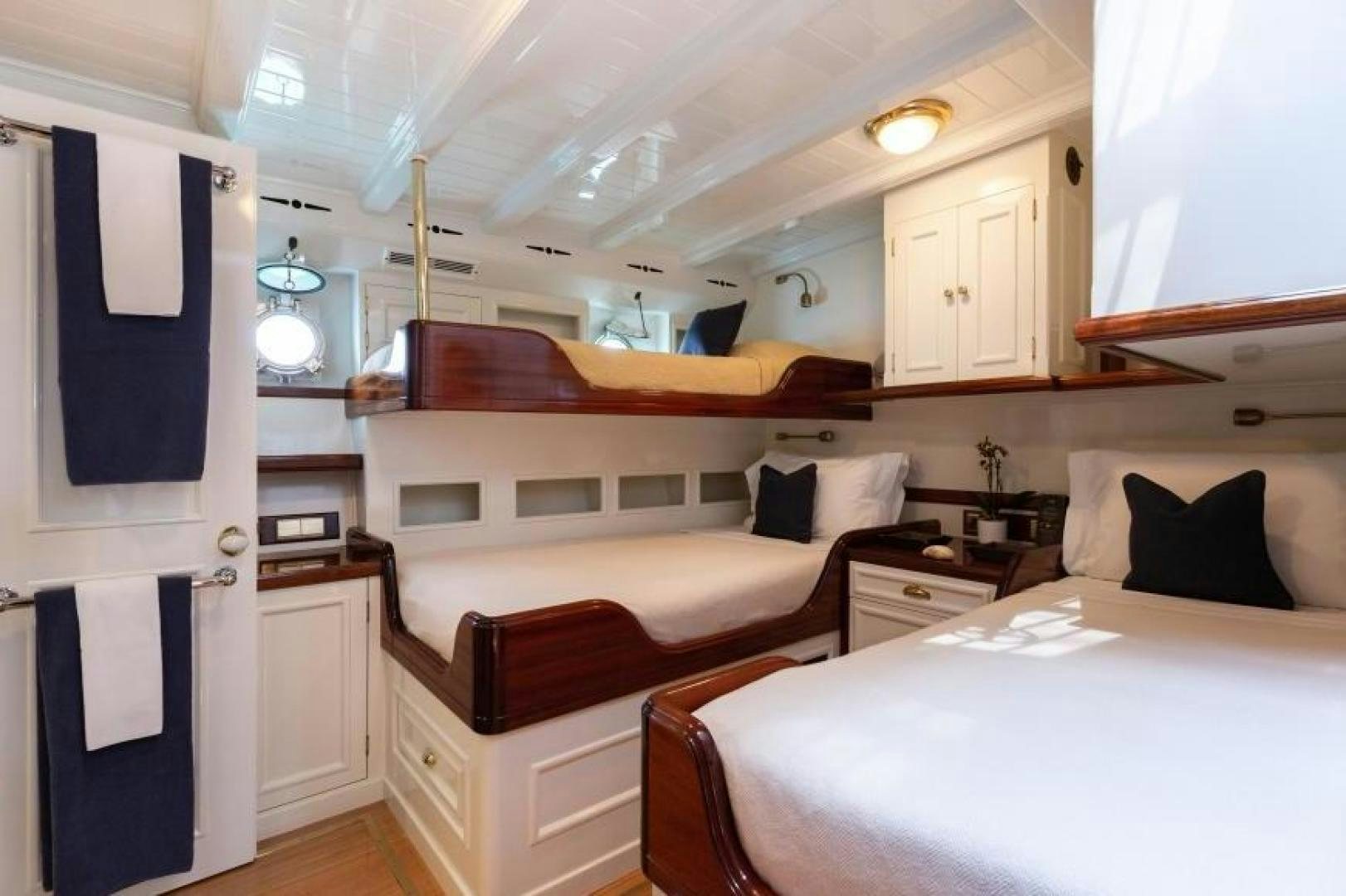 a room with two beds aboard NAEMA Yacht for Sale