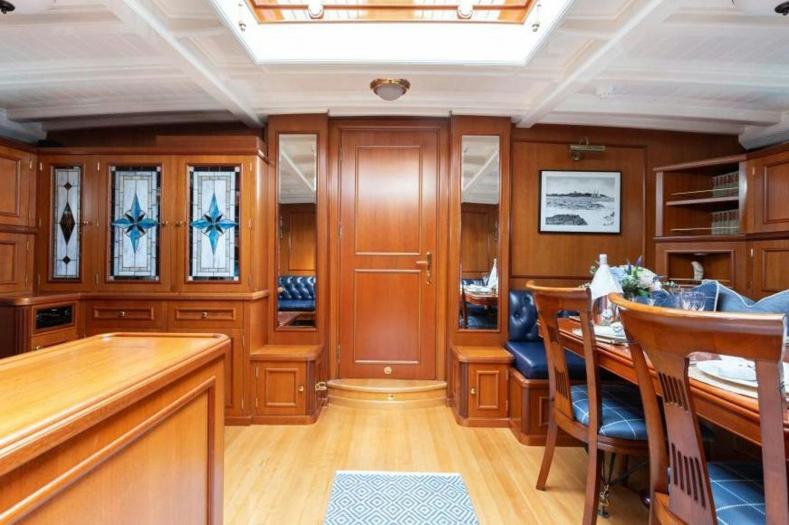 a room with wooden furniture aboard NAEMA Yacht for Sale