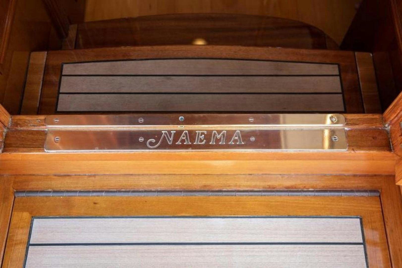 a wood cabinet with a name on it aboard NAEMA Yacht for Sale