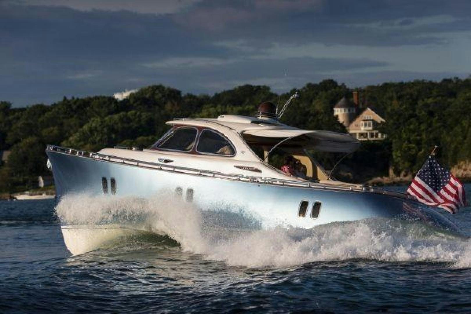 a white boat with a flag on it aboard BEYOND INFINITY Yacht for Sale