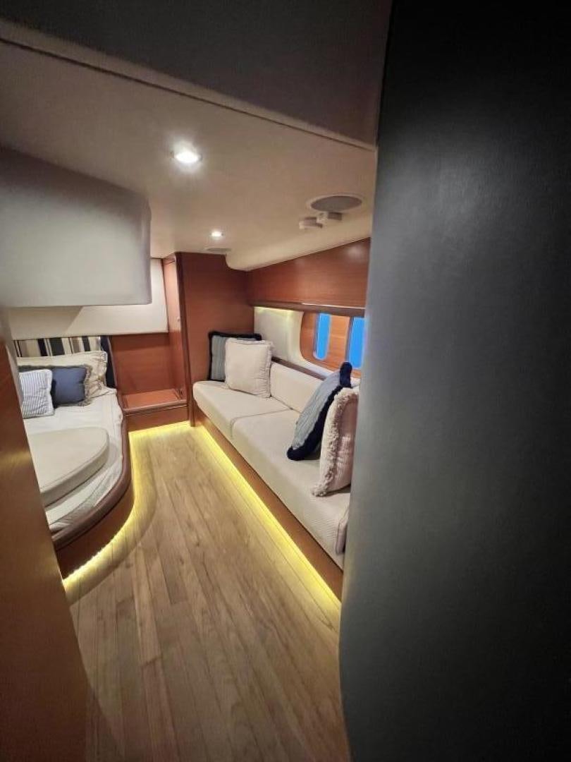 a bedroom with a bed and a couch aboard BEYOND INFINITY Yacht for Sale