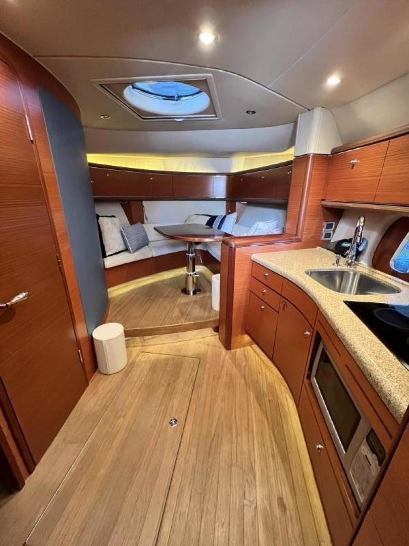 a kitchen with wooden cabinets aboard BEYOND INFINITY Yacht for Sale