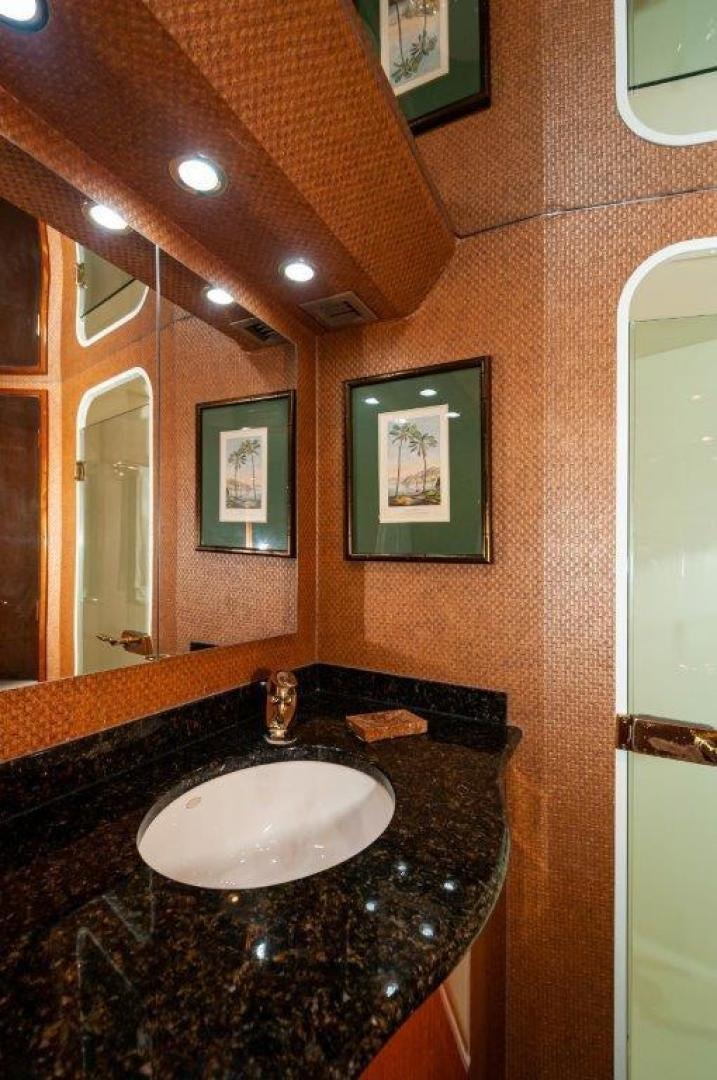 a bathroom with a sink and mirror aboard MISS PAULA V Yacht for Sale