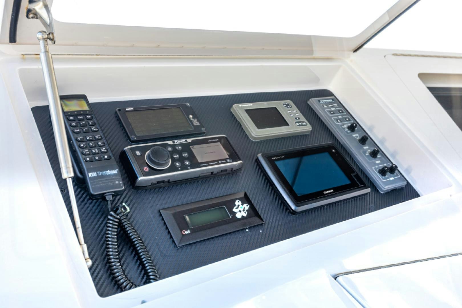 a group of cell phones on a car seat aboard MISS PAULA V Yacht for Sale