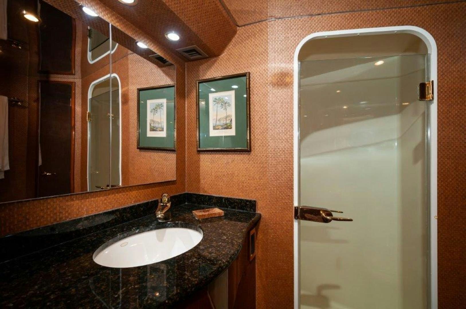 a bathroom with a sink and mirrors aboard MISS PAULA V Yacht for Sale