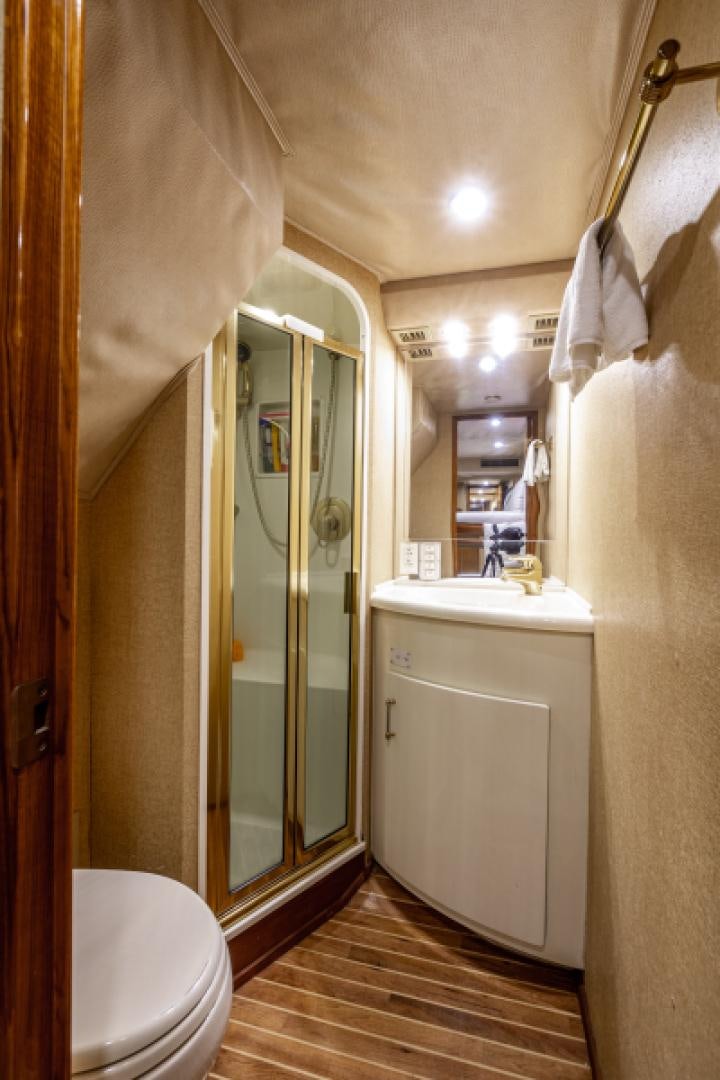 a bathroom with a glass shower door aboard MISS PAULA V Yacht for Sale