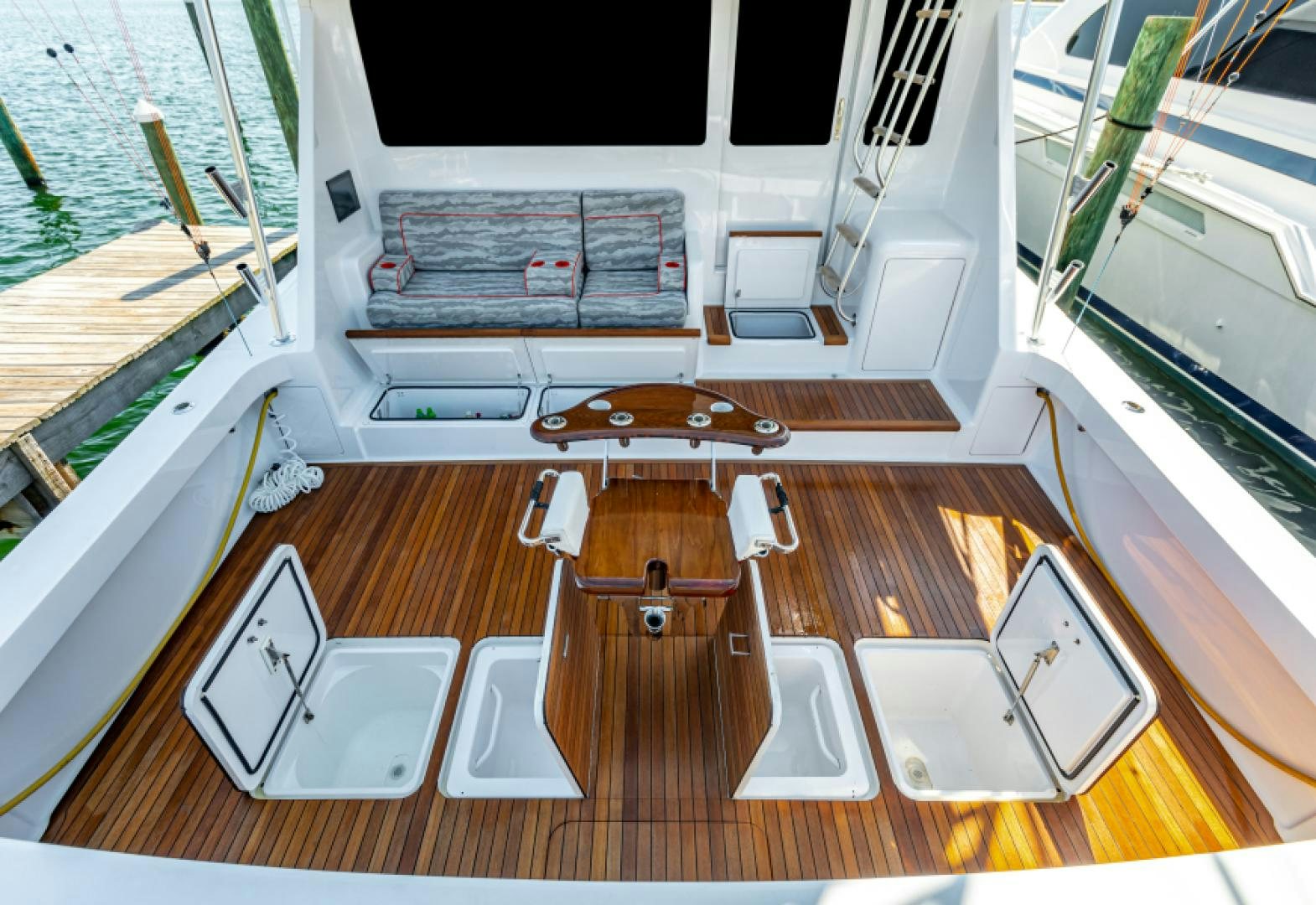 a room with a table and chairs aboard MISS PAULA V Yacht for Sale