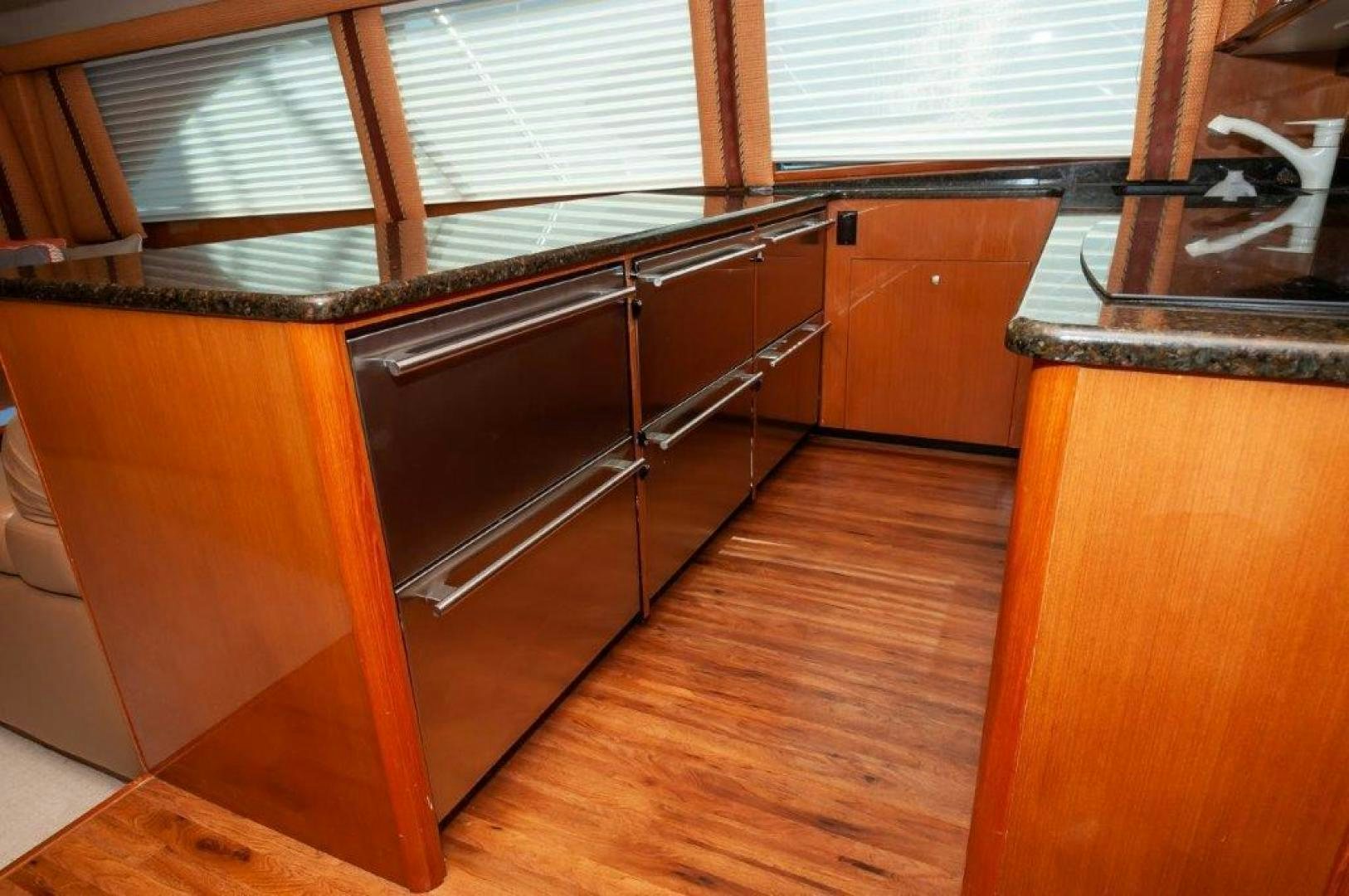 a room with a wood floor and a large window aboard MISS PAULA V Yacht for Sale
