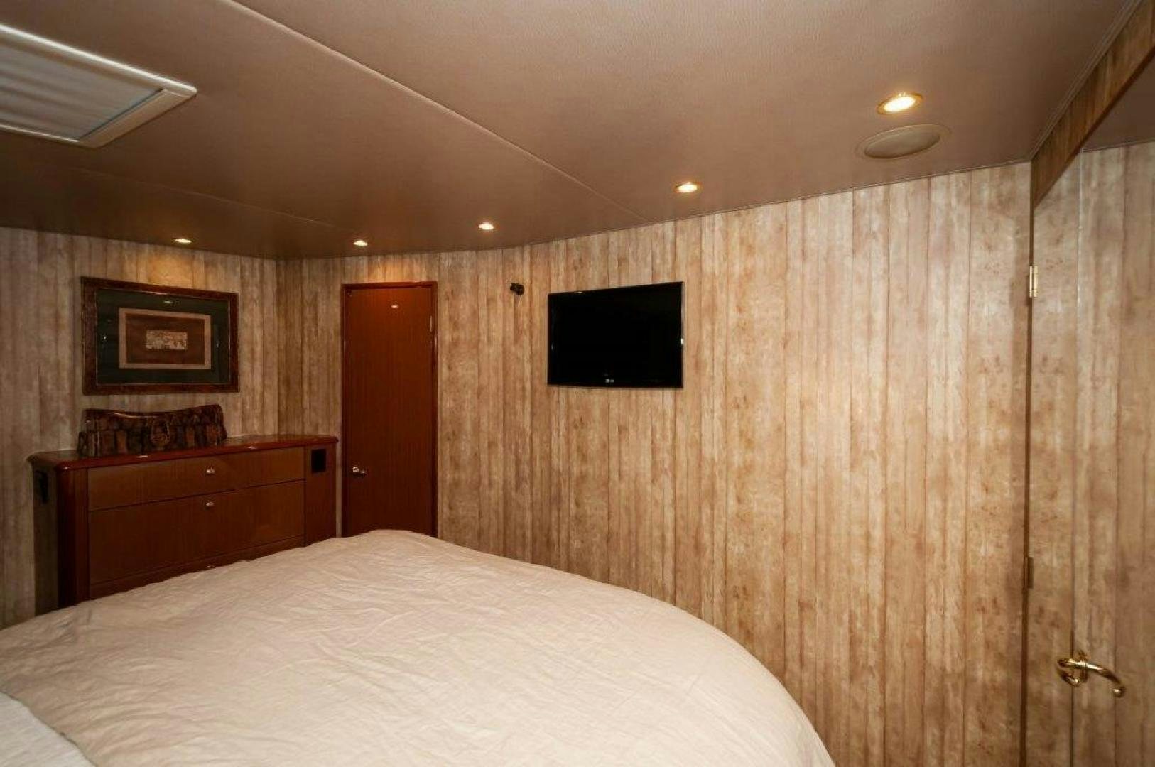 a room with a television and a bed aboard MISS PAULA V Yacht for Sale
