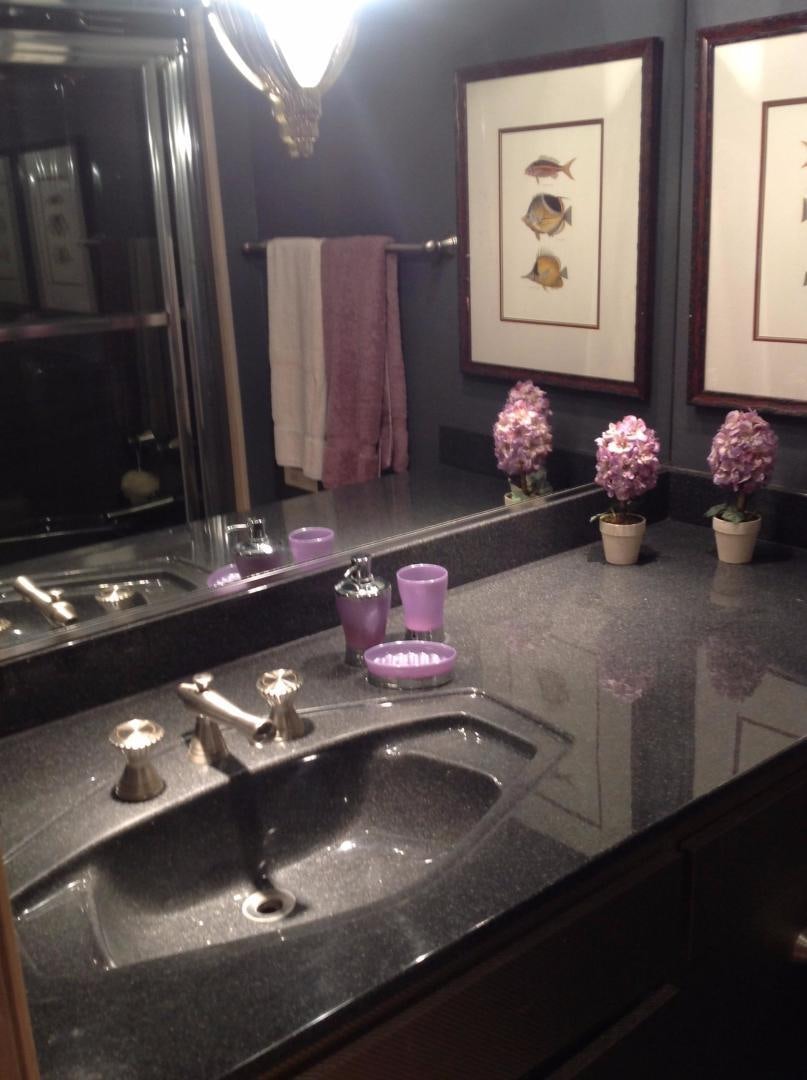 a bathroom with a sink and a mirror aboard AUDACITY Yacht for Sale