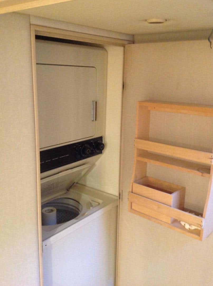 a white kitchen with a stove and oven aboard AUDACITY Yacht for Sale