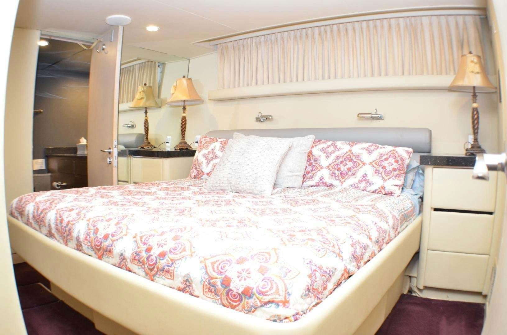 a bed with pink and white sheets aboard AUDACITY Yacht for Sale