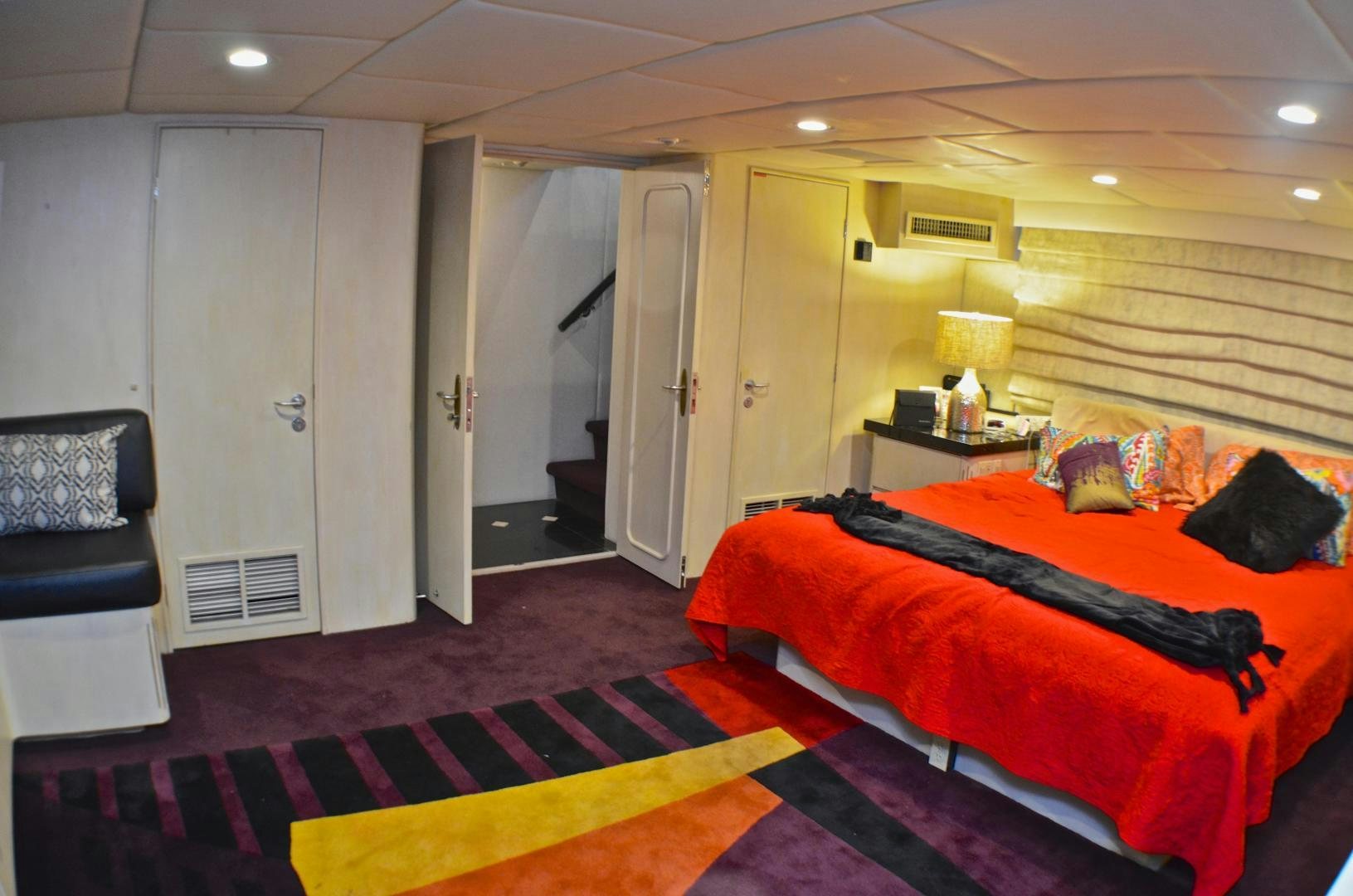a bedroom with a bed and a desk aboard AUDACITY Yacht for Sale