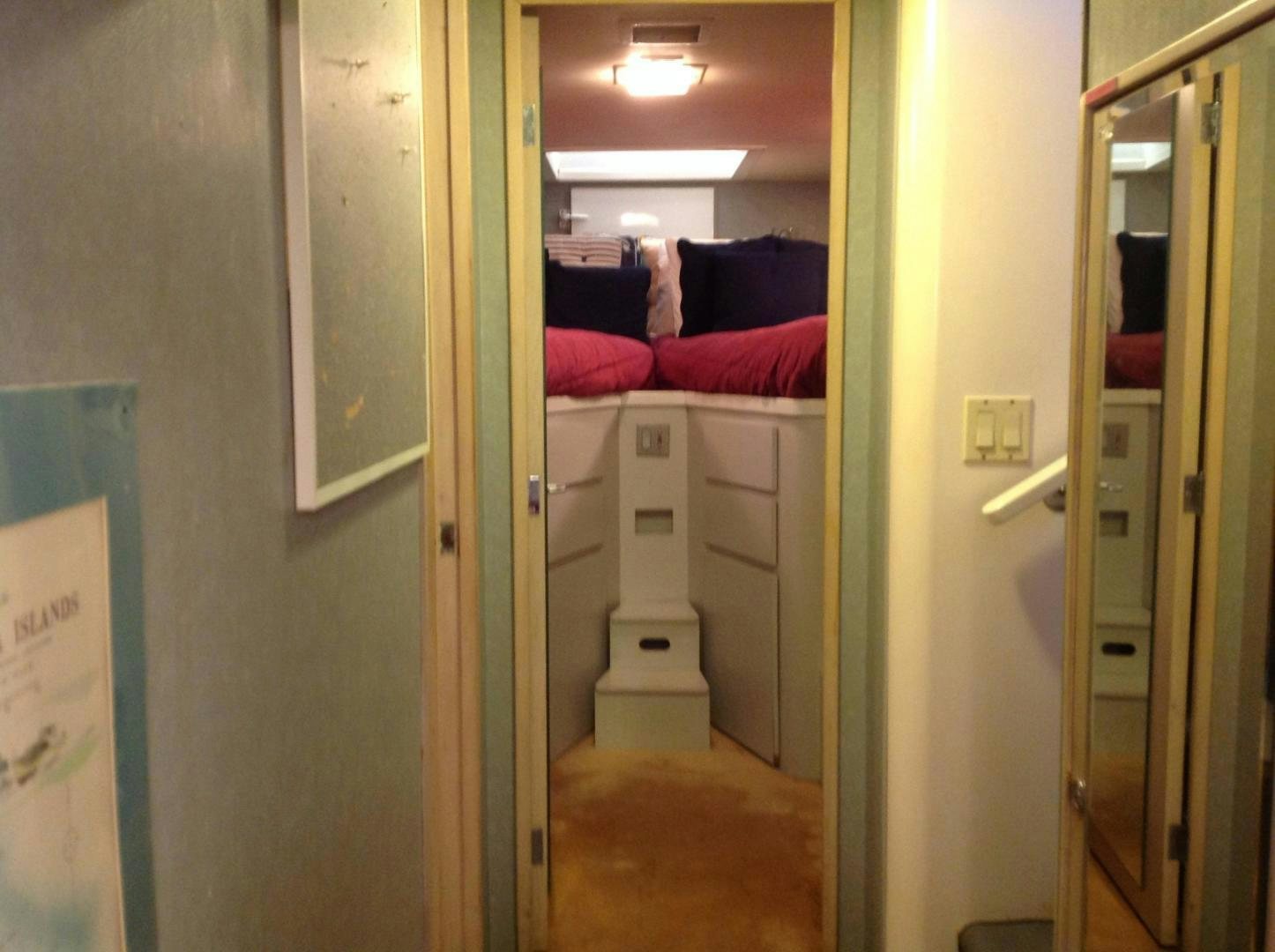 a room with a bed and a door aboard AUDACITY Yacht for Sale
