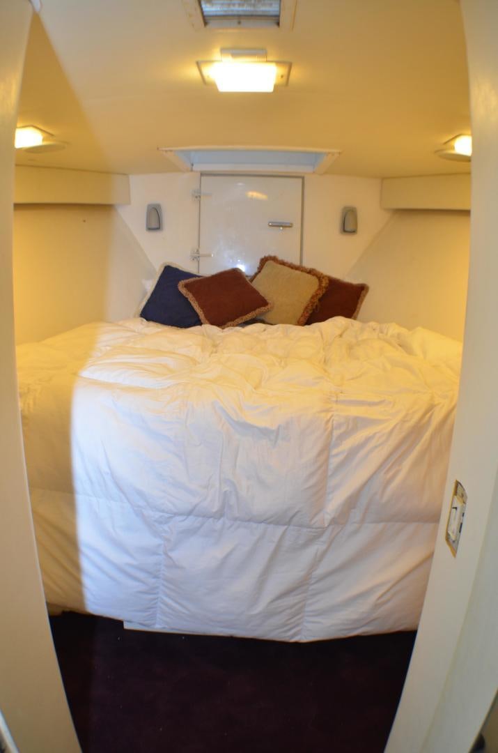 a bed with white sheets aboard AUDACITY Yacht for Sale