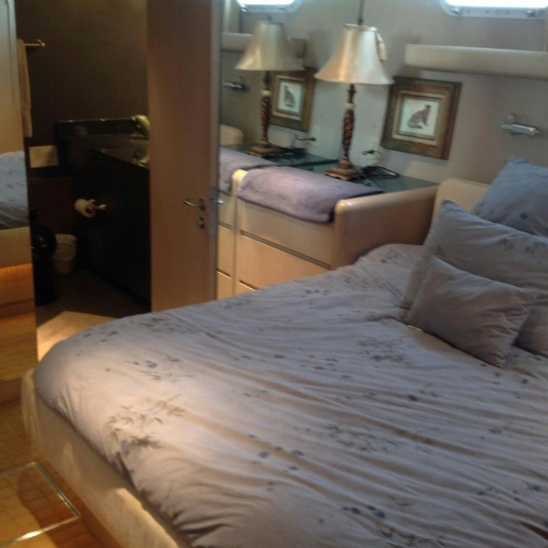 a bed with a white comforter aboard AUDACITY Yacht for Sale
