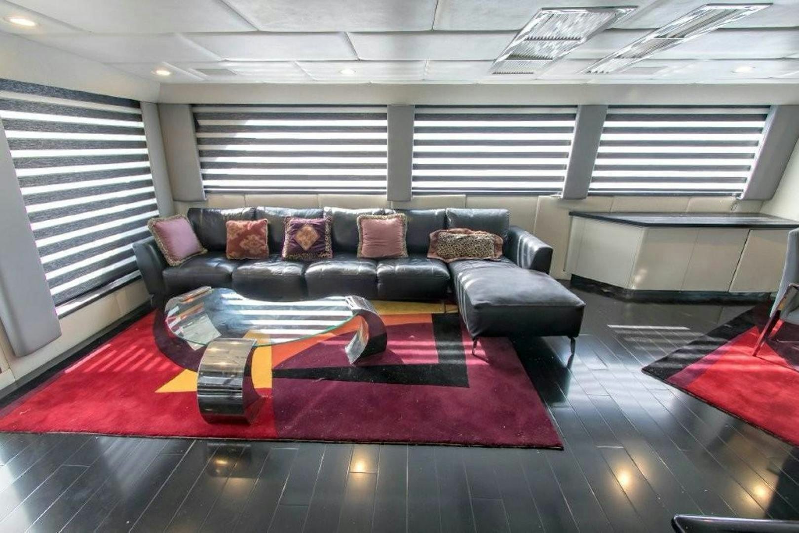 a living room with a red rug aboard AUDACITY Yacht for Sale