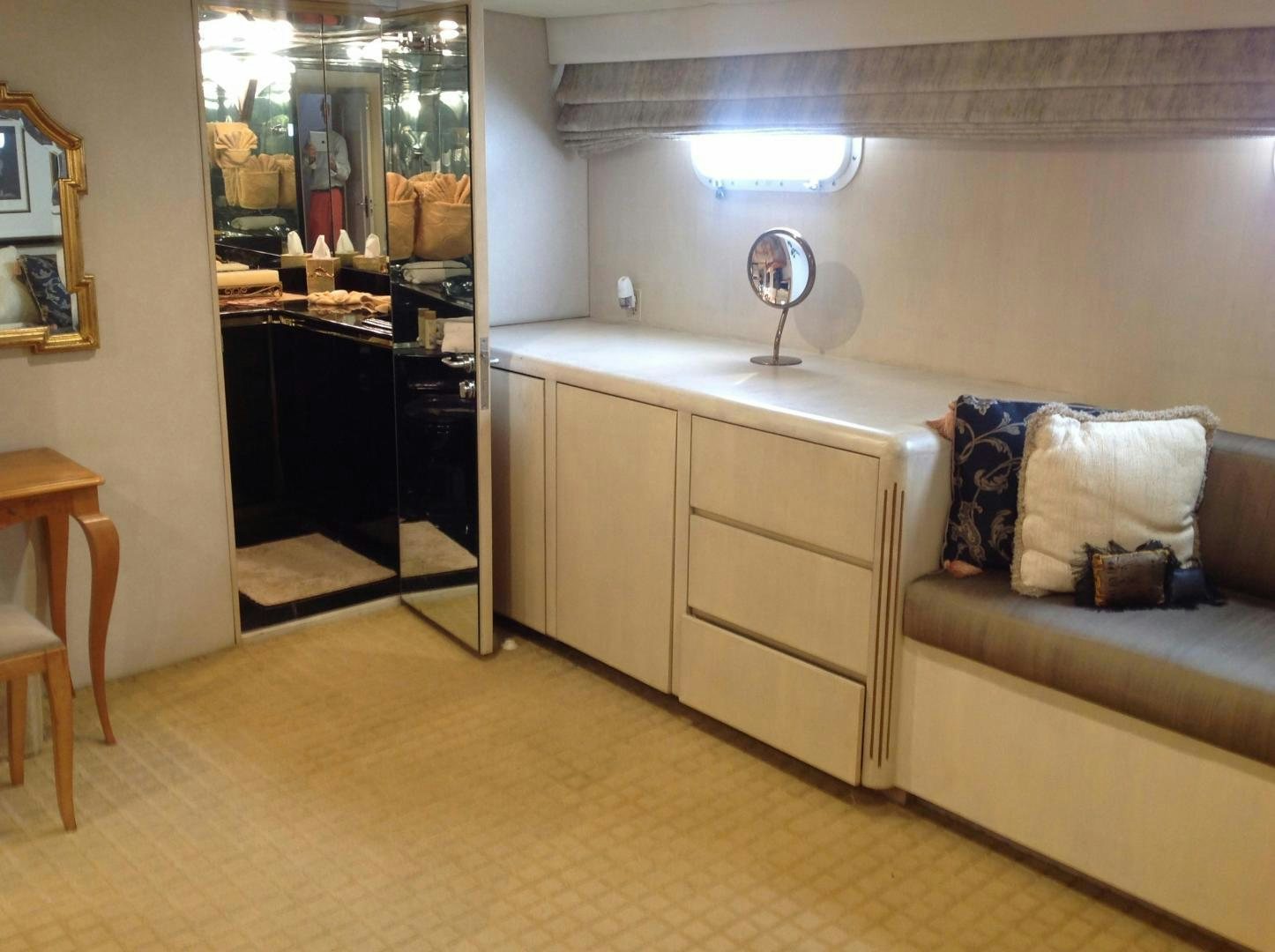 a living room with a couch and a mirror aboard AUDACITY Yacht for Sale