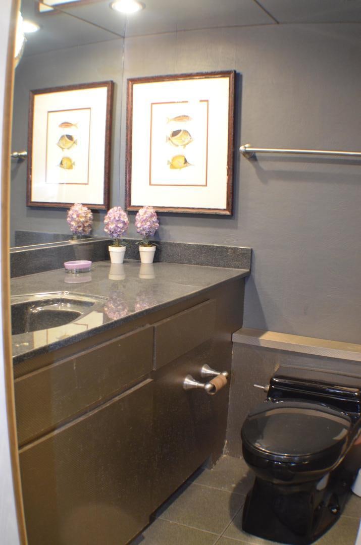 a bathroom with a countertop sink and a mirror aboard AUDACITY Yacht for Sale