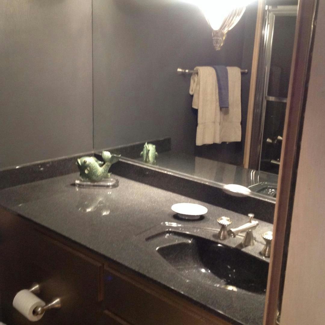 a bathroom with a large mirror aboard AUDACITY Yacht for Sale