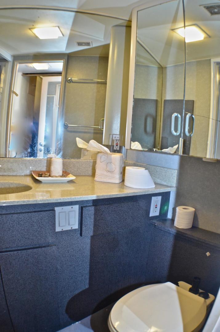 a bathroom with a large mirror aboard AUDACITY Yacht for Sale