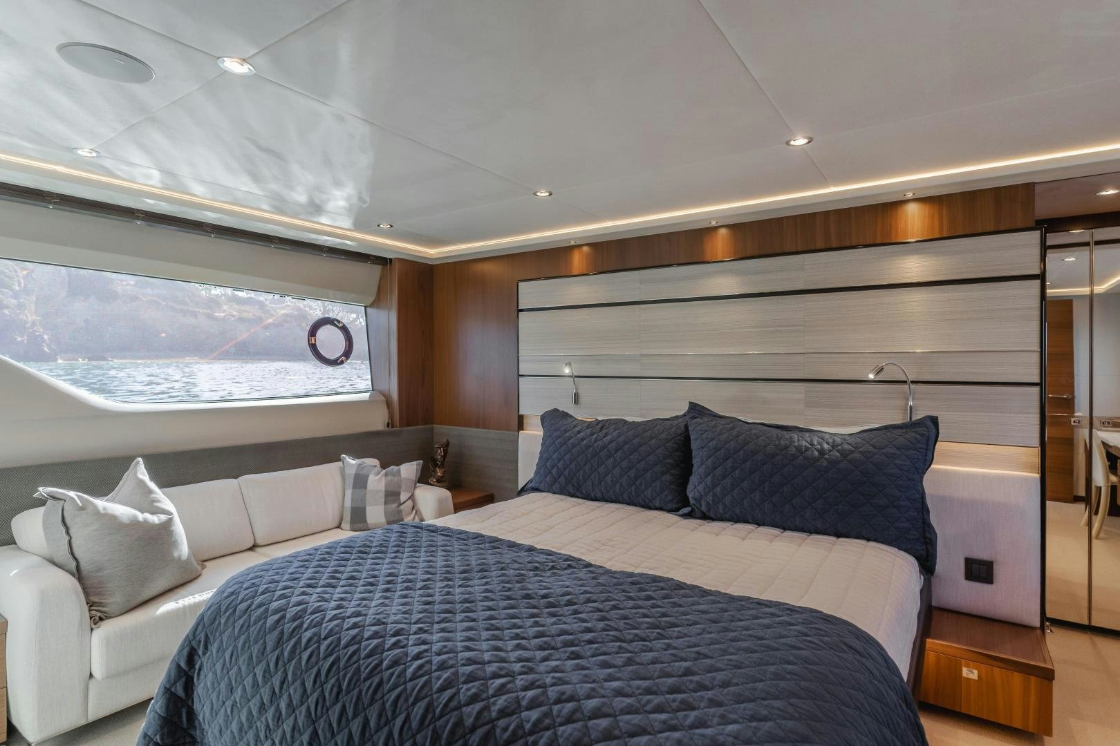 a room with a bed and a couch aboard SEXSEA Yacht for Sale