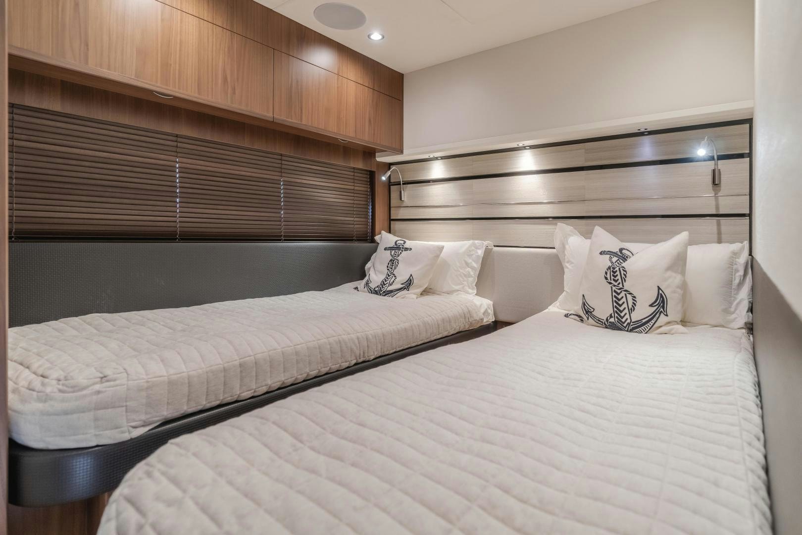 a bed with a white comforter aboard SEXSEA Yacht for Sale