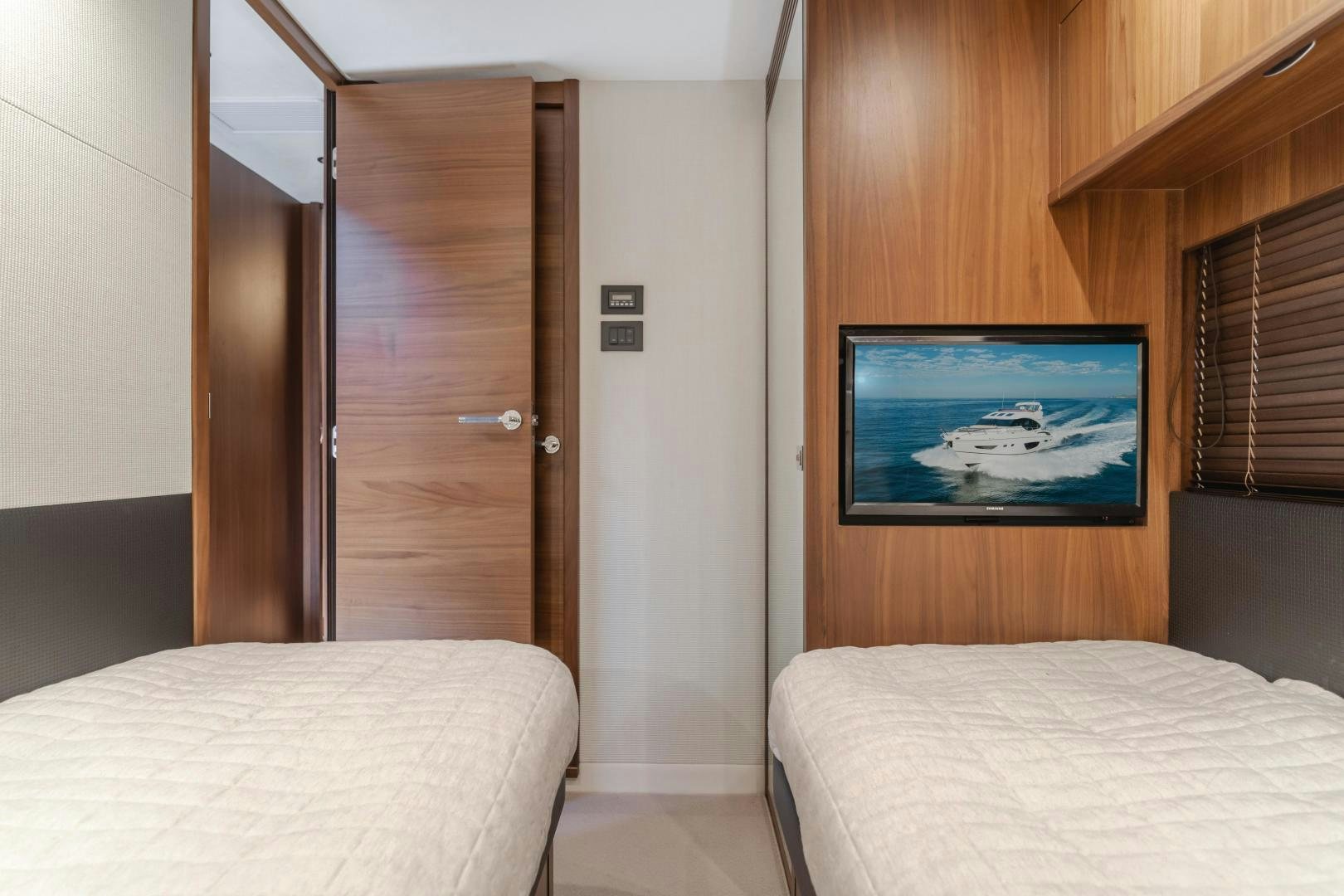 a bed and a television in a room aboard SEXSEA Yacht for Sale